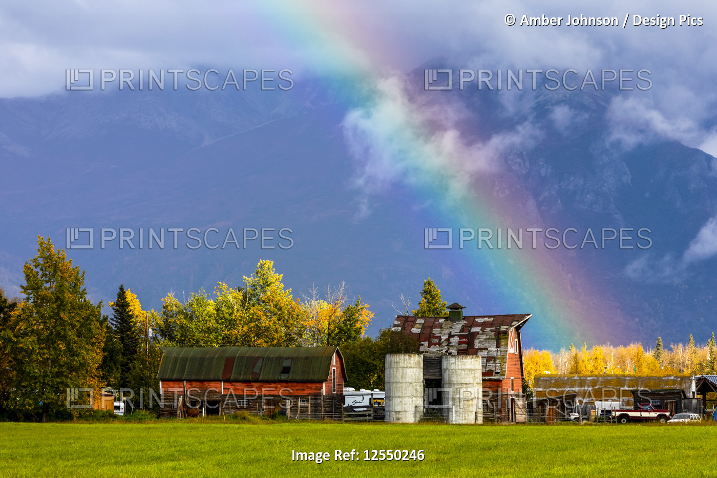 A rainbow ends over a farm, Mat-Su Valley, South-central Alaska; Palmer, ...