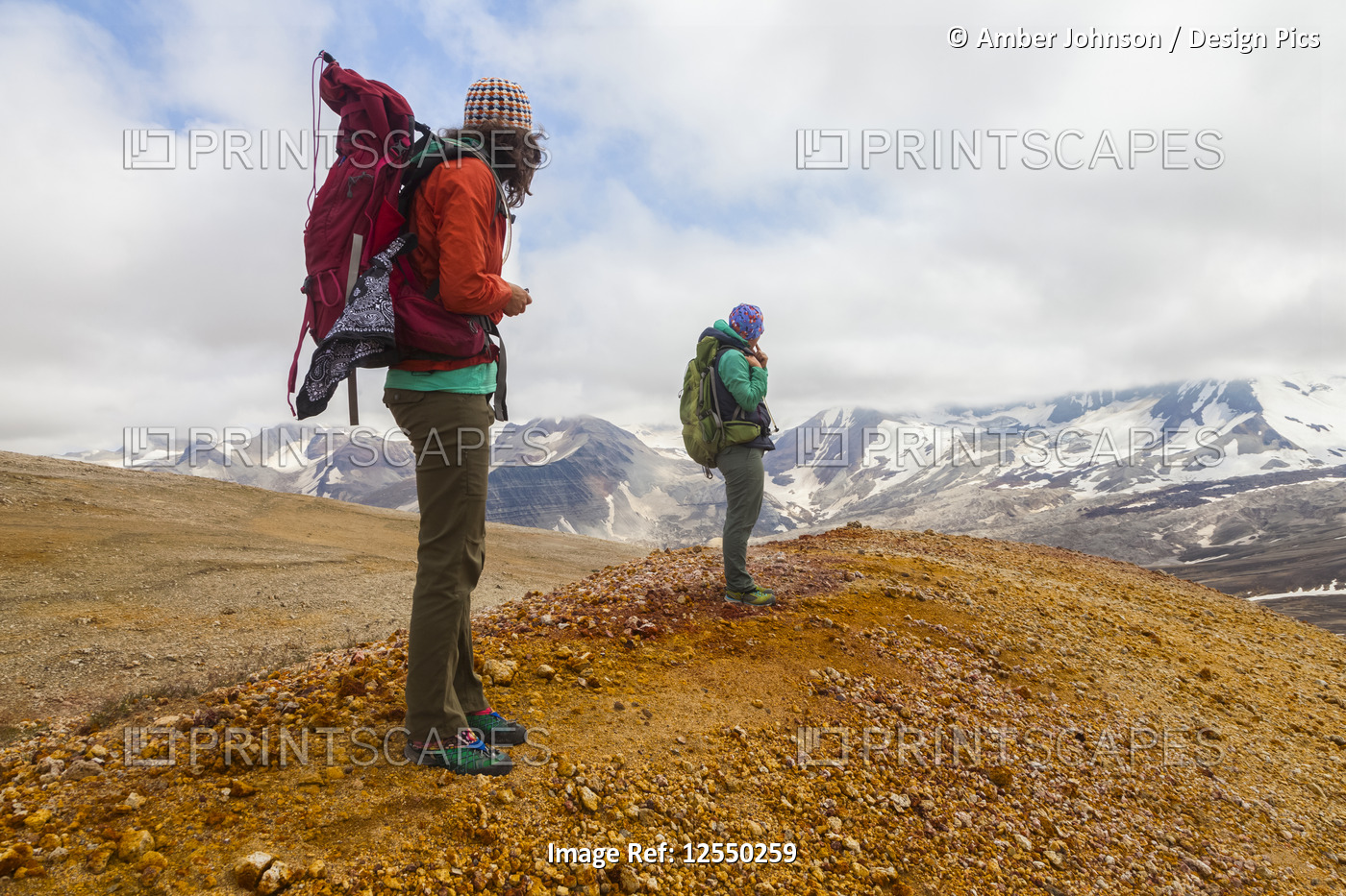 Two women backpacking and taking in the view of Mount Katmai from the ...