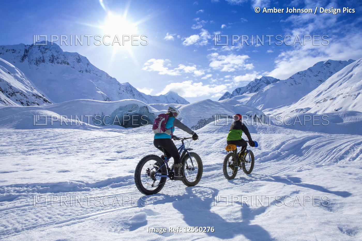 Two women fat biking in front of Skookum Glacier, Chugach National Forest, ...
