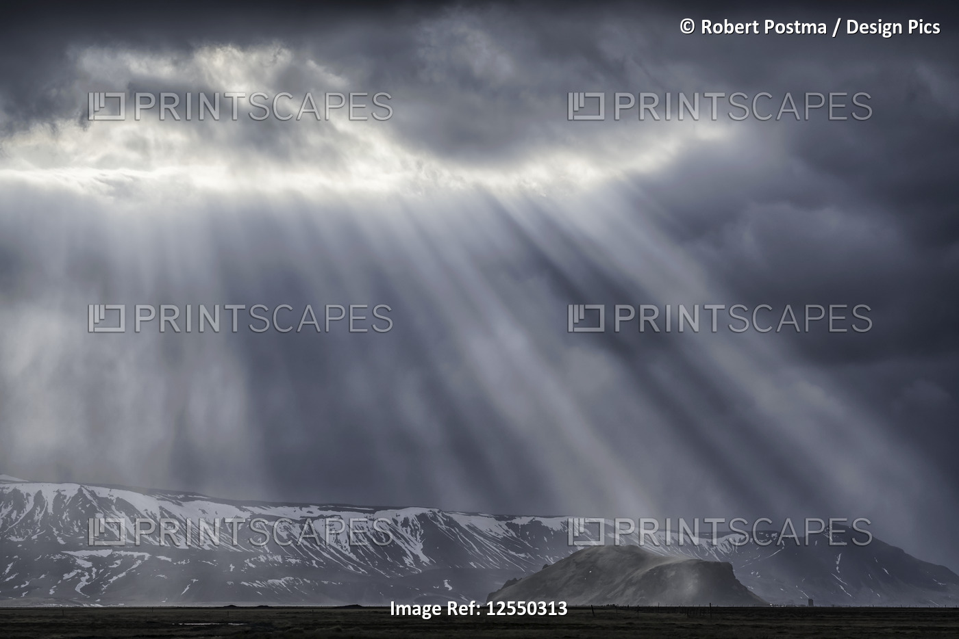 Dramatic sunlight beams punch through the clouds along the South coast of ...