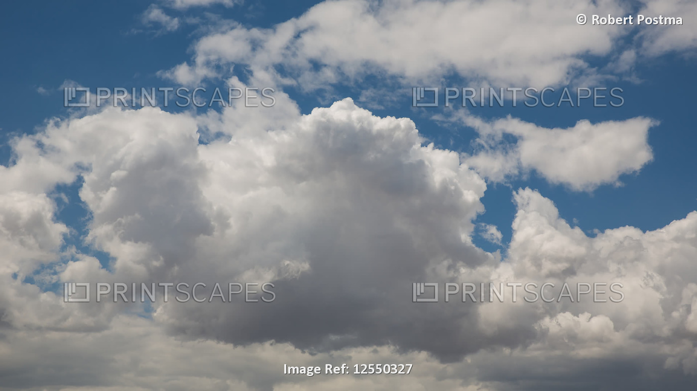 Clouds moving across a blue sky and gathering in a storm formation; Cochabamba, ...