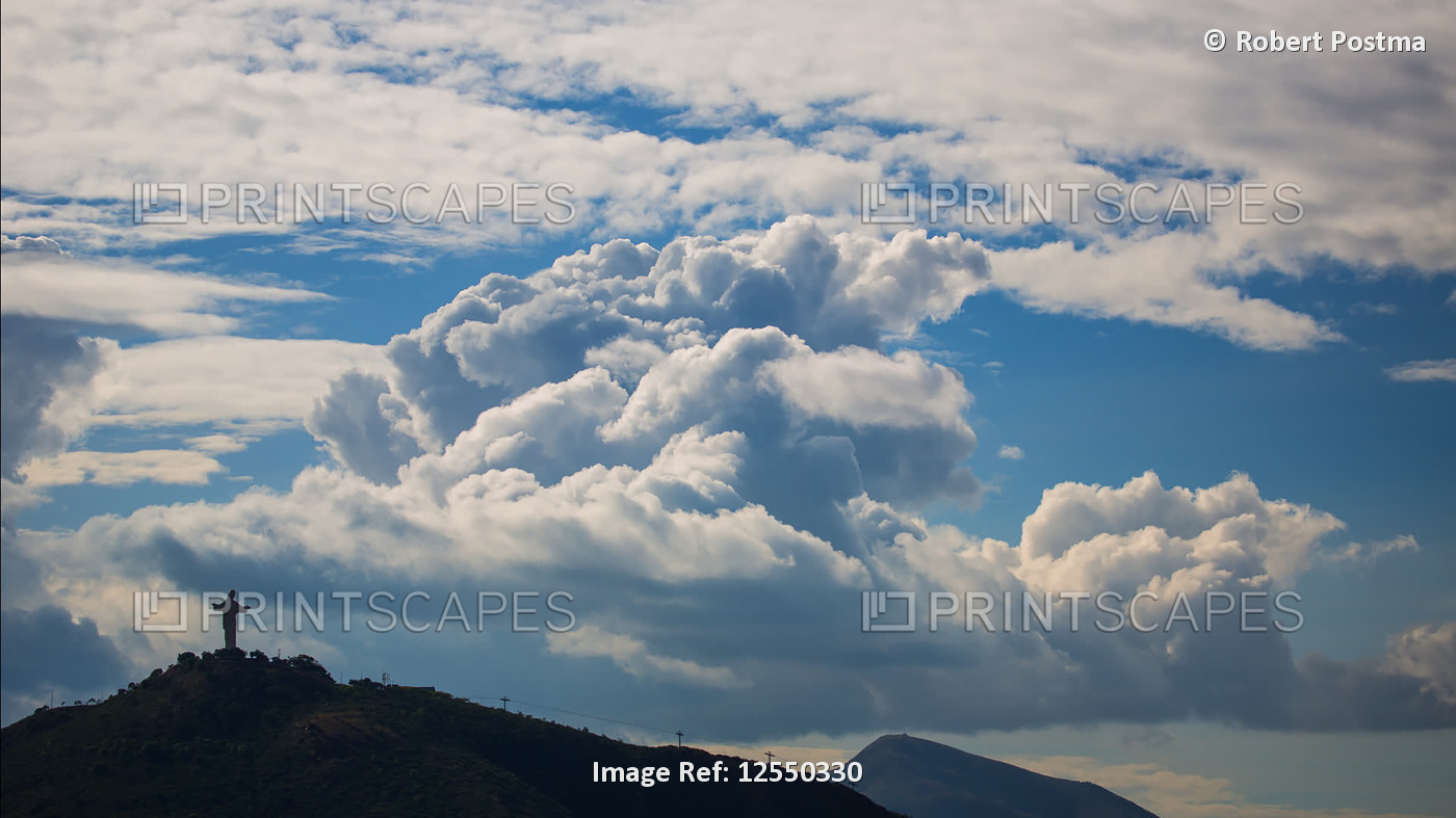 Clouds moving across the sky over a statue of Christ on a hilltop; Cochabamba, ...