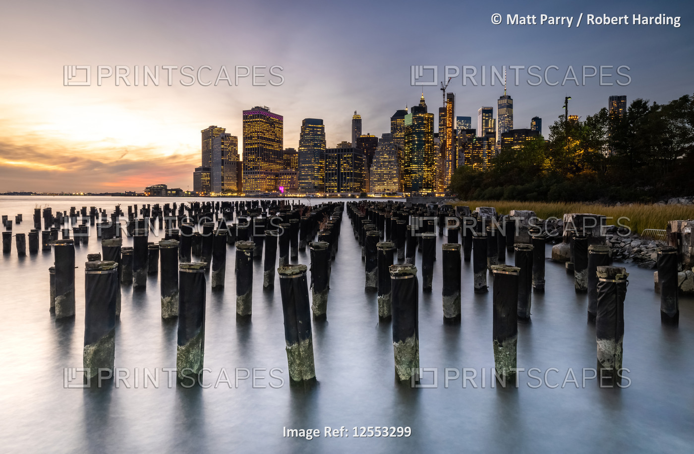 Long exposure of the lights of Lower Manhattan during sunset as seen from Brooklyn Bridge Park.