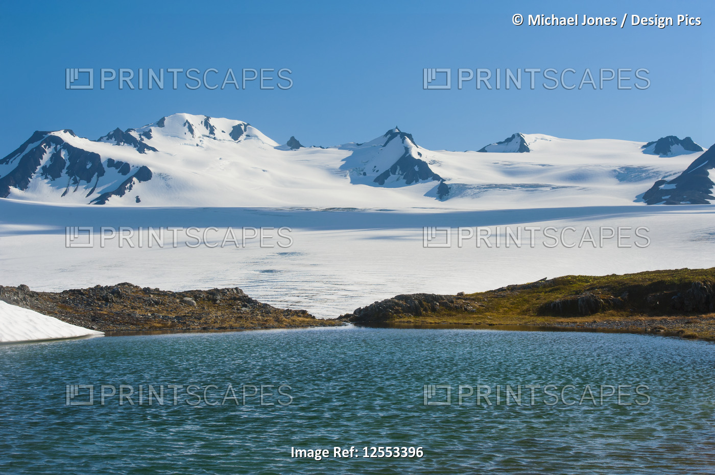 An unnamed kettle pond in Kenai Fjords National Park on a sunny summer day; ...