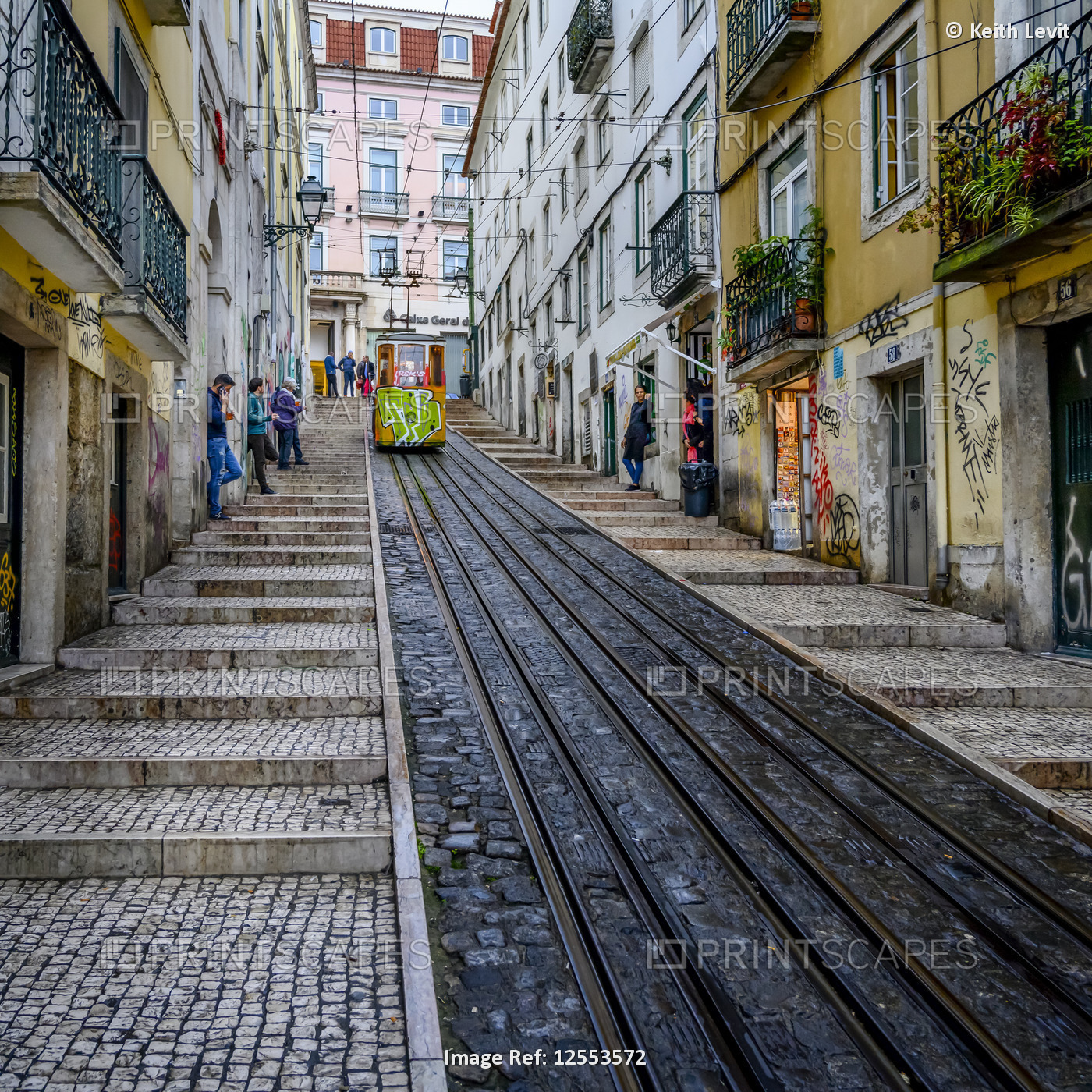 City Life in Lisbon, with a street car and people waiting outside buildings ...