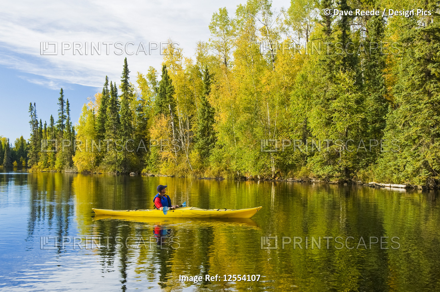 A man kayaking at MacKay Lake, Northern Saskatchewan; Saskatchewan, Canada