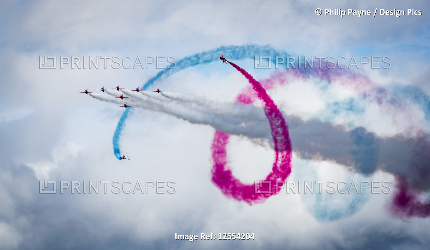 Red Arrows air display, nine planes flying in formation with colourful ...