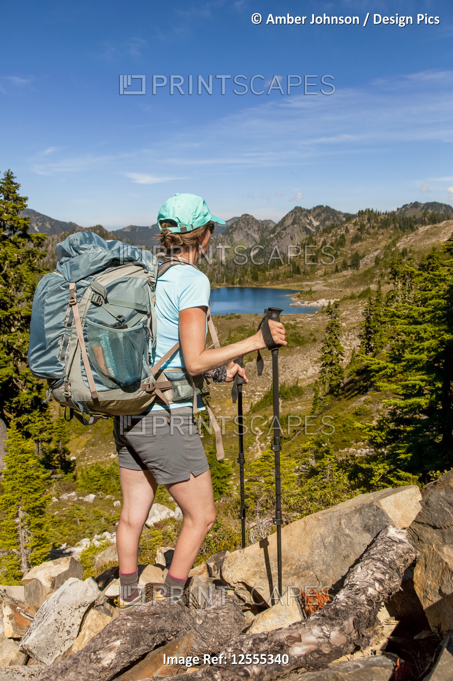 Female backpacker on High Divide Trail pausing to take a look at the view of ...