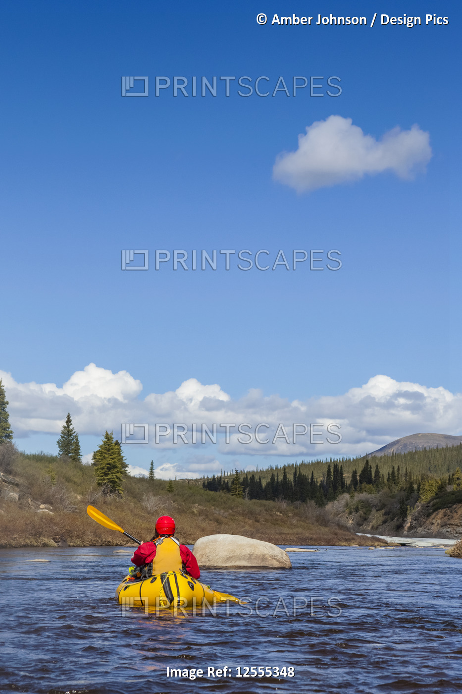 Woman packrafting and negotiating a tributary of the Charley River in ...