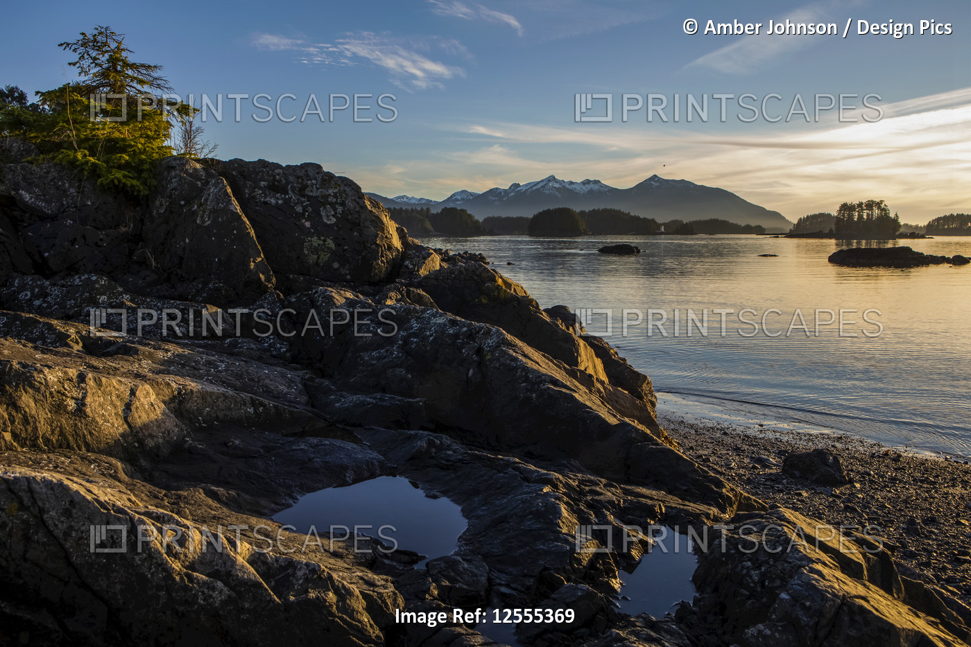 Late day winter sun on rocky beach overlooking Crescent Bay; Sitka, Alaska, ...