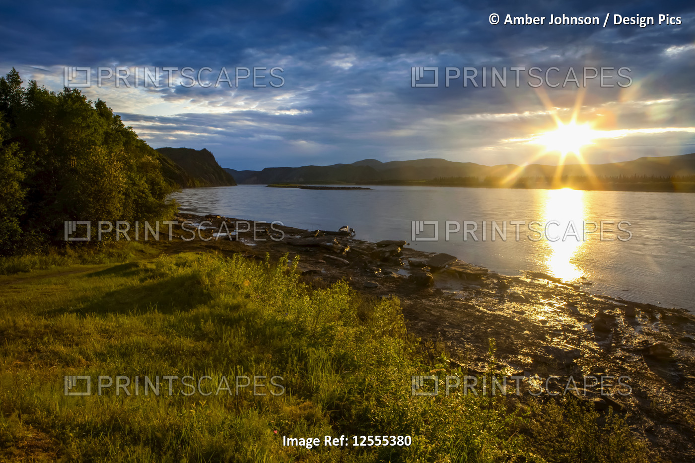 Sun going down on the Yukon River in summer; Alaska, United States of America