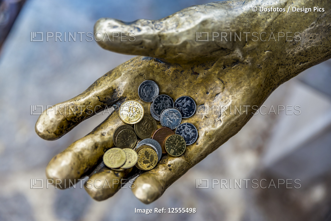 Fisherman sculpture with coins in it's hand in a harbour; Opatija, ...