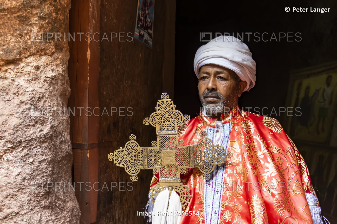 Priest holding an elaborate processional cross at the Tomb of Adam in the ...