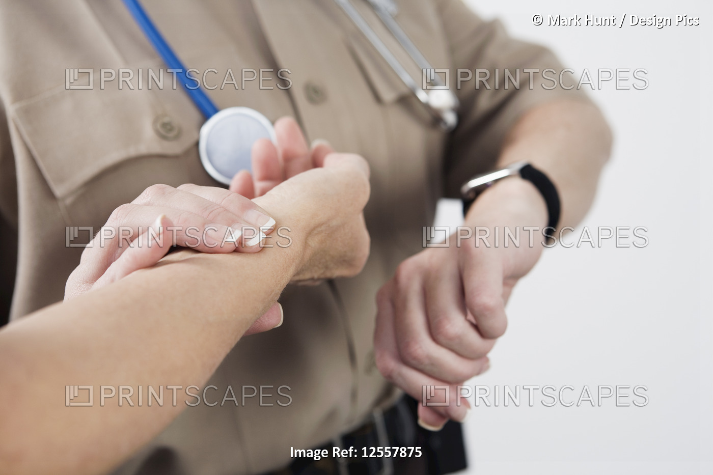 View of Emergency Medical Service officer checking the pulse of a patient