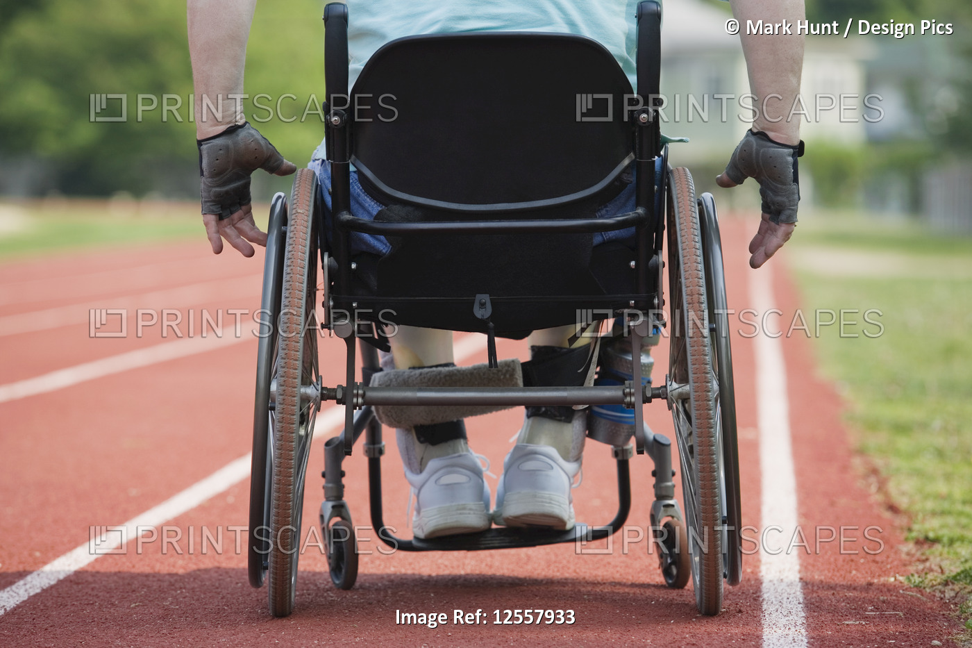 Man with Muscular Dystrophy sitting on a wheel chair on a race track