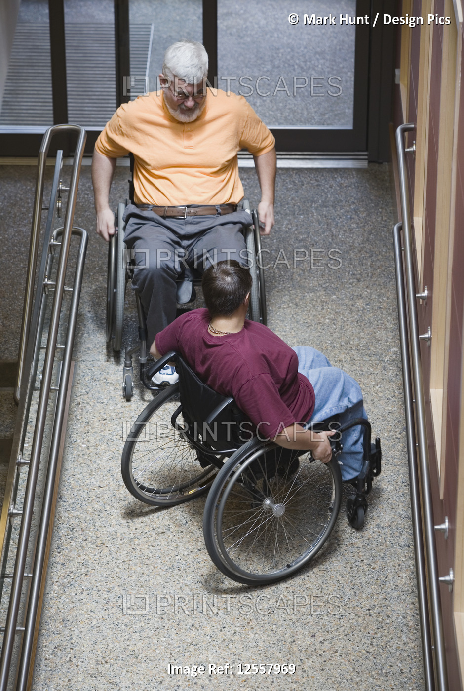 High angle view of a mature man with Muscular Dystrophy and a young woman ...