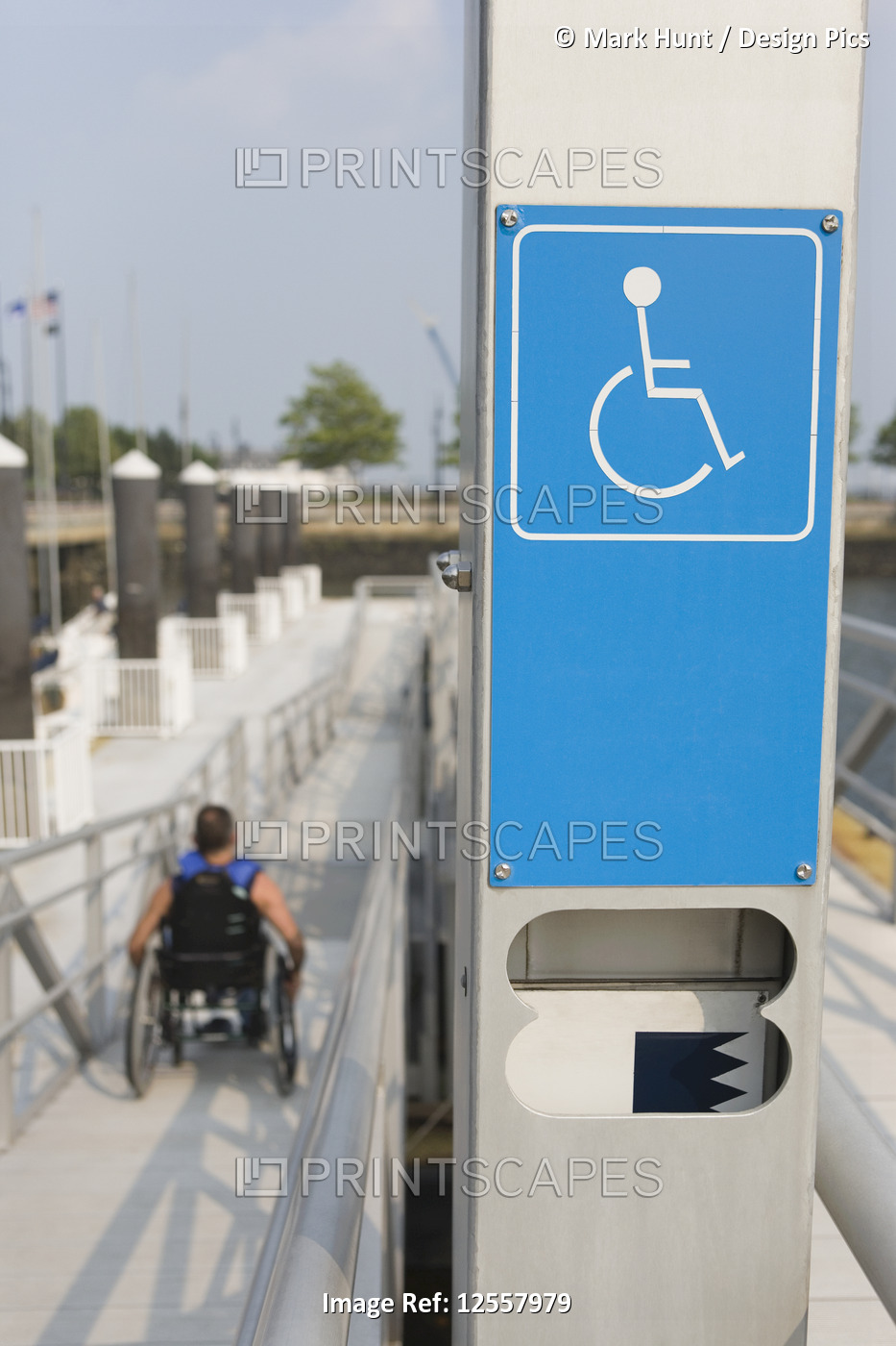 Close-up of a Disabled signboard with a man sitting in wheelchair in the ...