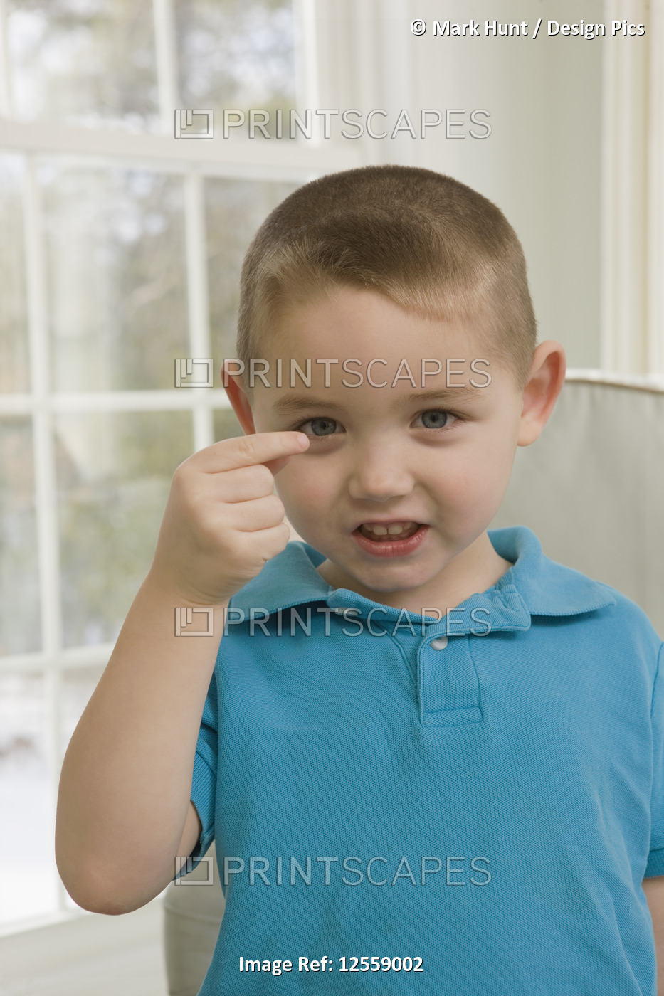 Boy signing the letter 'G' in American sign language