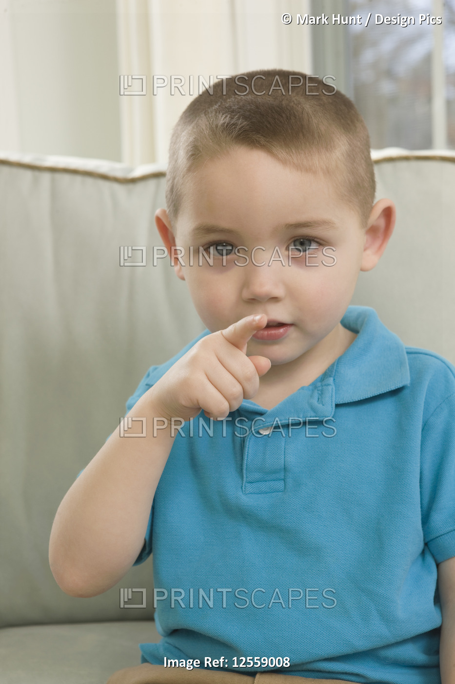 Boy signing the word 'You' in American sign language