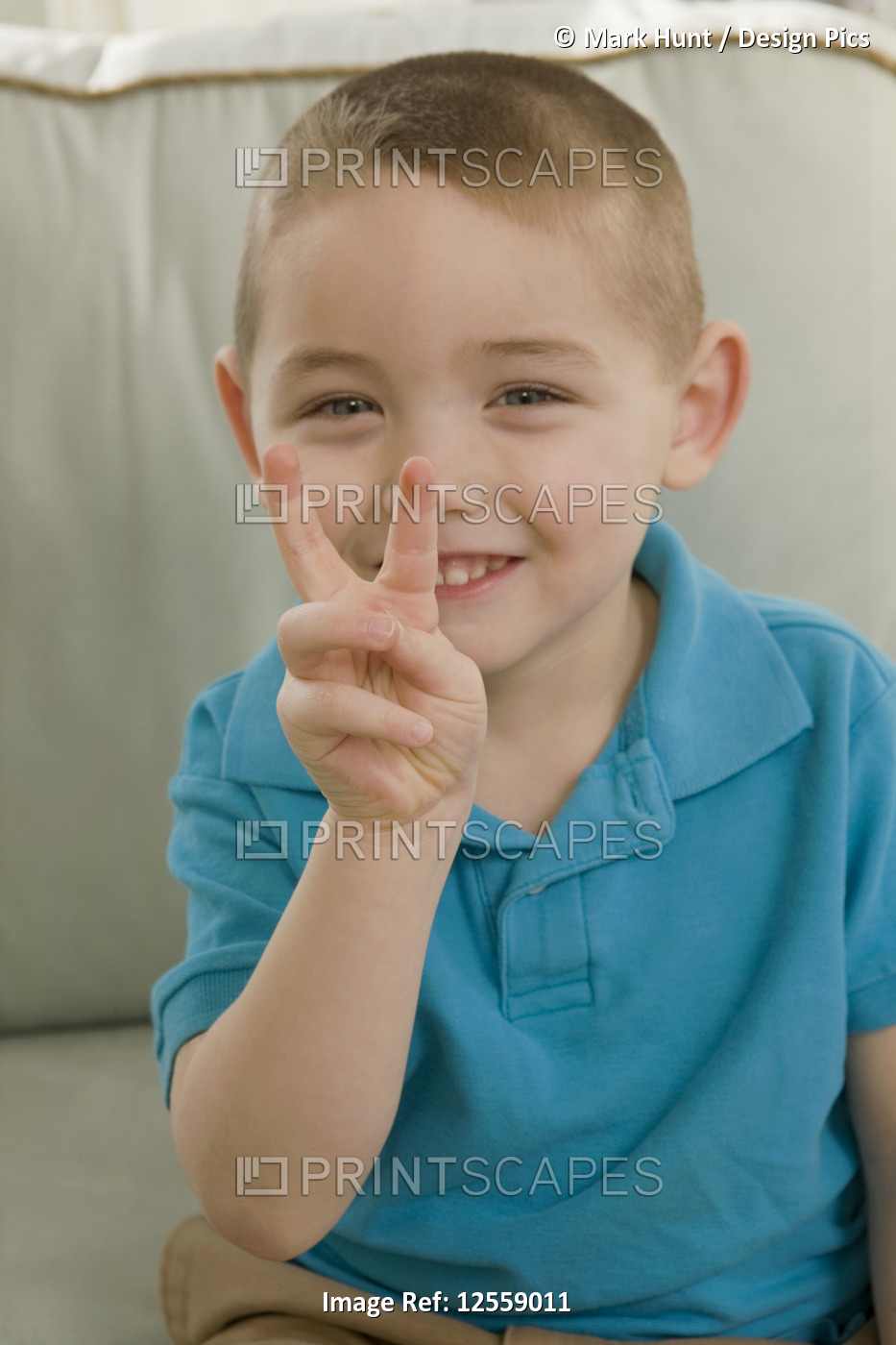 Boy signing the letter 'V' in American sign language