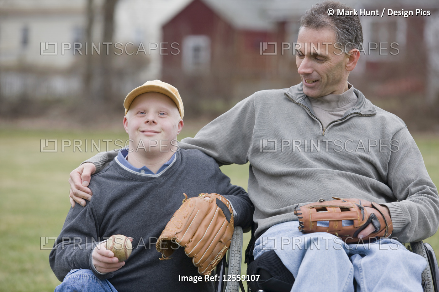Disabled man smiling with his son with Down Syndrome