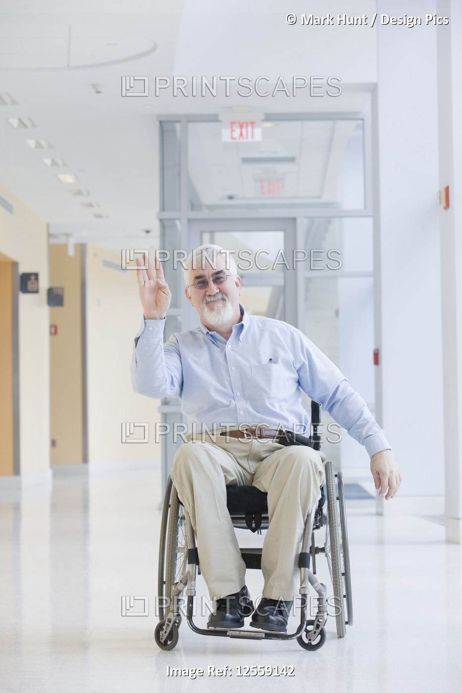 University professor with Muscular Dystrophy waving his hand in a corridor of a ...