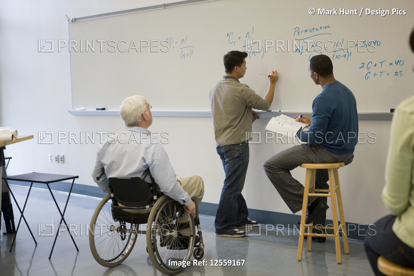 University professor with Muscular Dystrophy with his students in a classroom