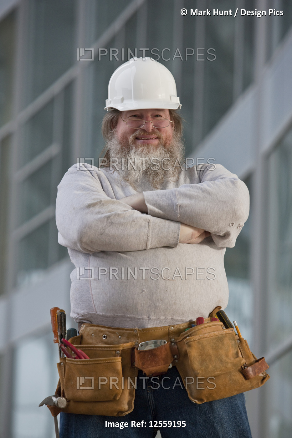 Construction worker standing with his arms crossed