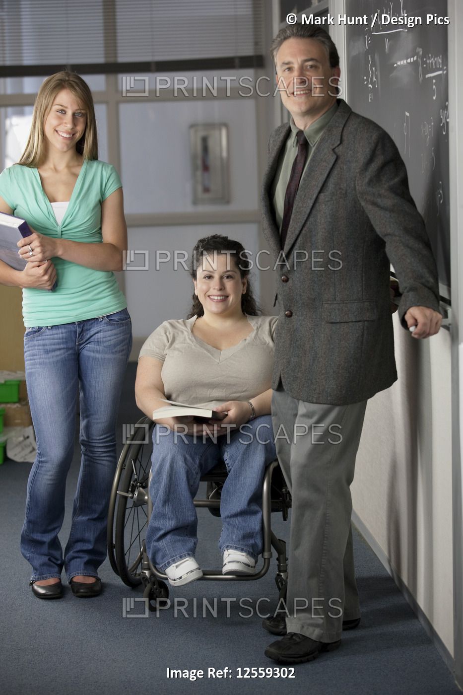 Professor and students smiling in a classroom, one with Spina Bifida