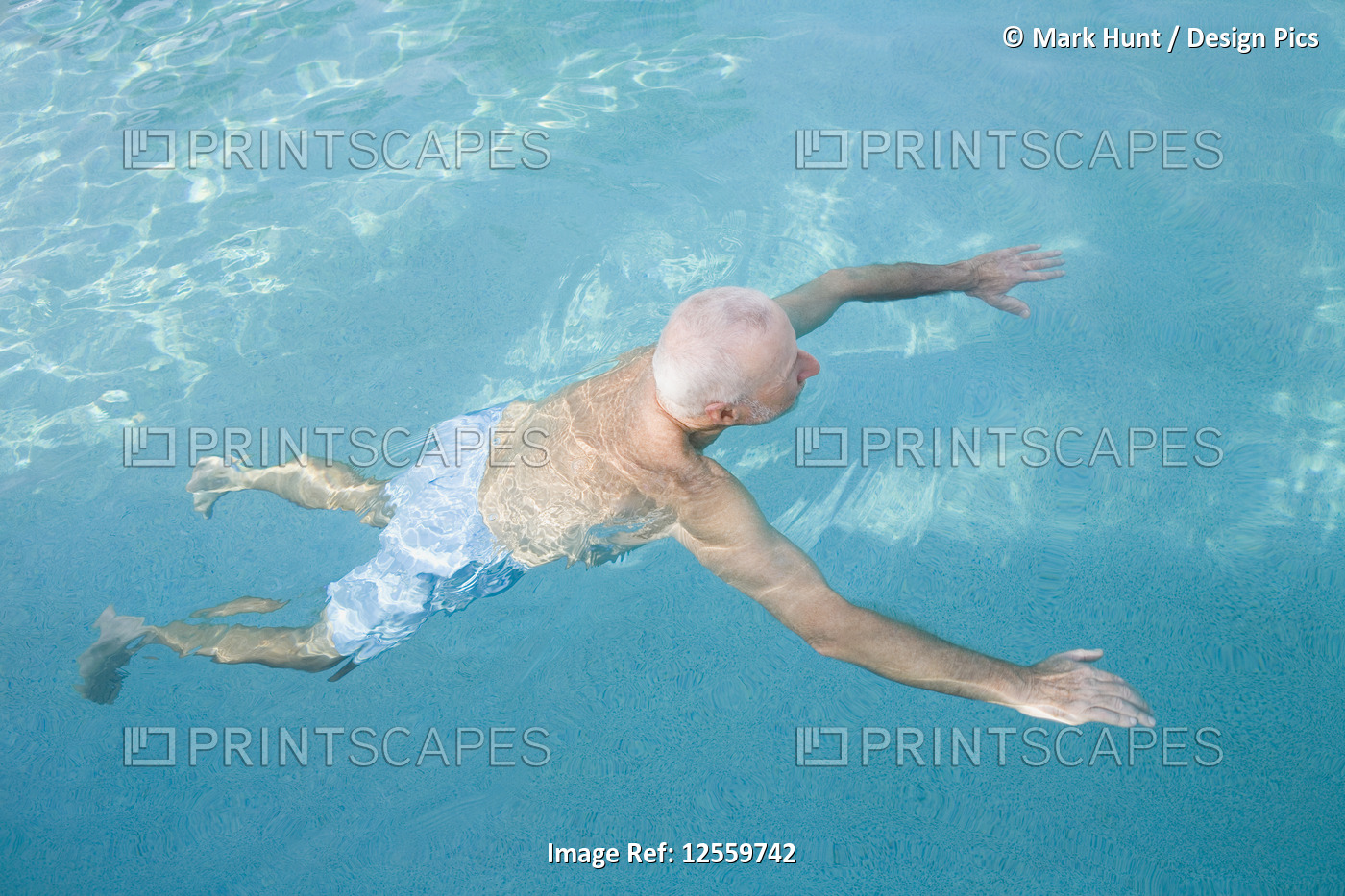 High angle view of a senior man in a swimming pool, Florida, USA