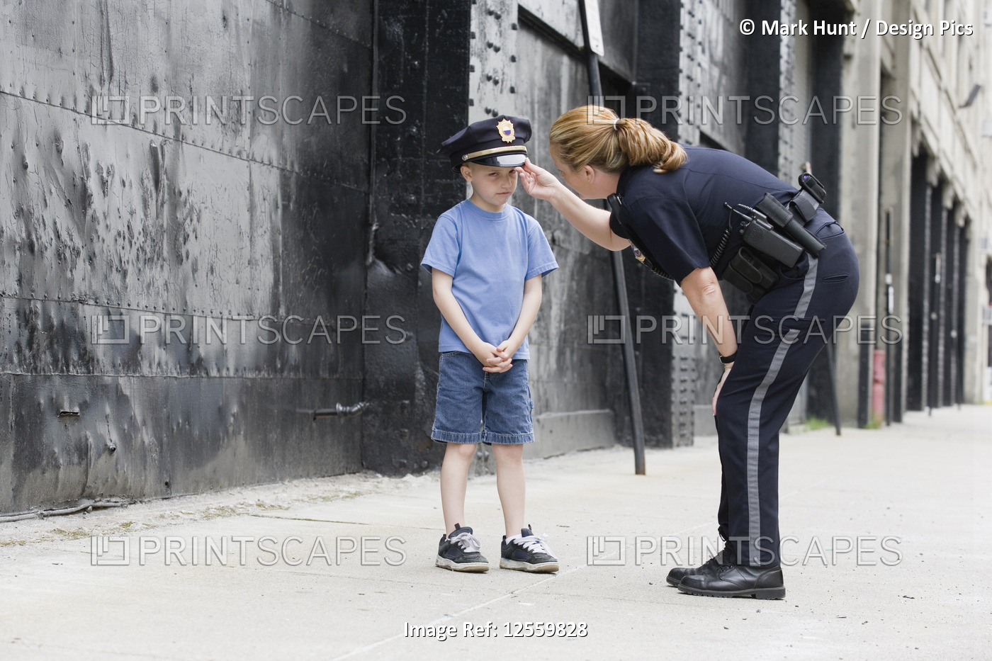 Woman police officer talking to a boy.