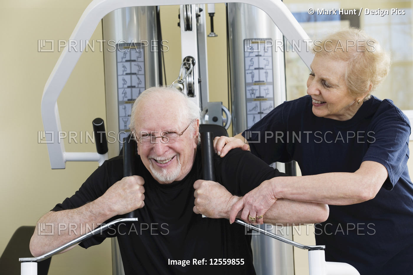 Senior couple working out on exercise equipment in a gym