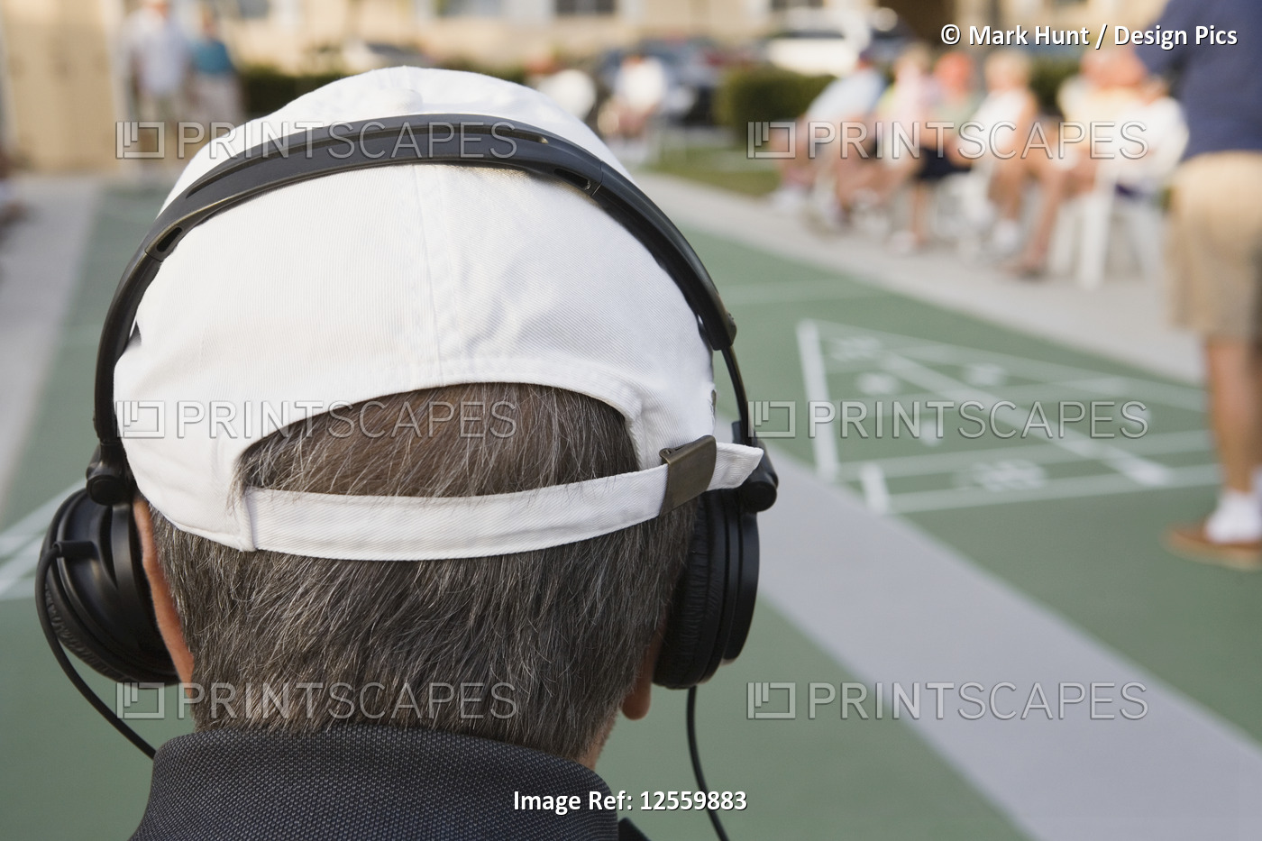 Rear view of a senior man wearing headphones