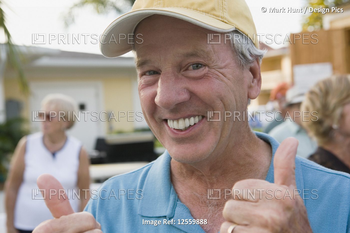 Portrait of a senior man showing a thumbs up sign and smiling