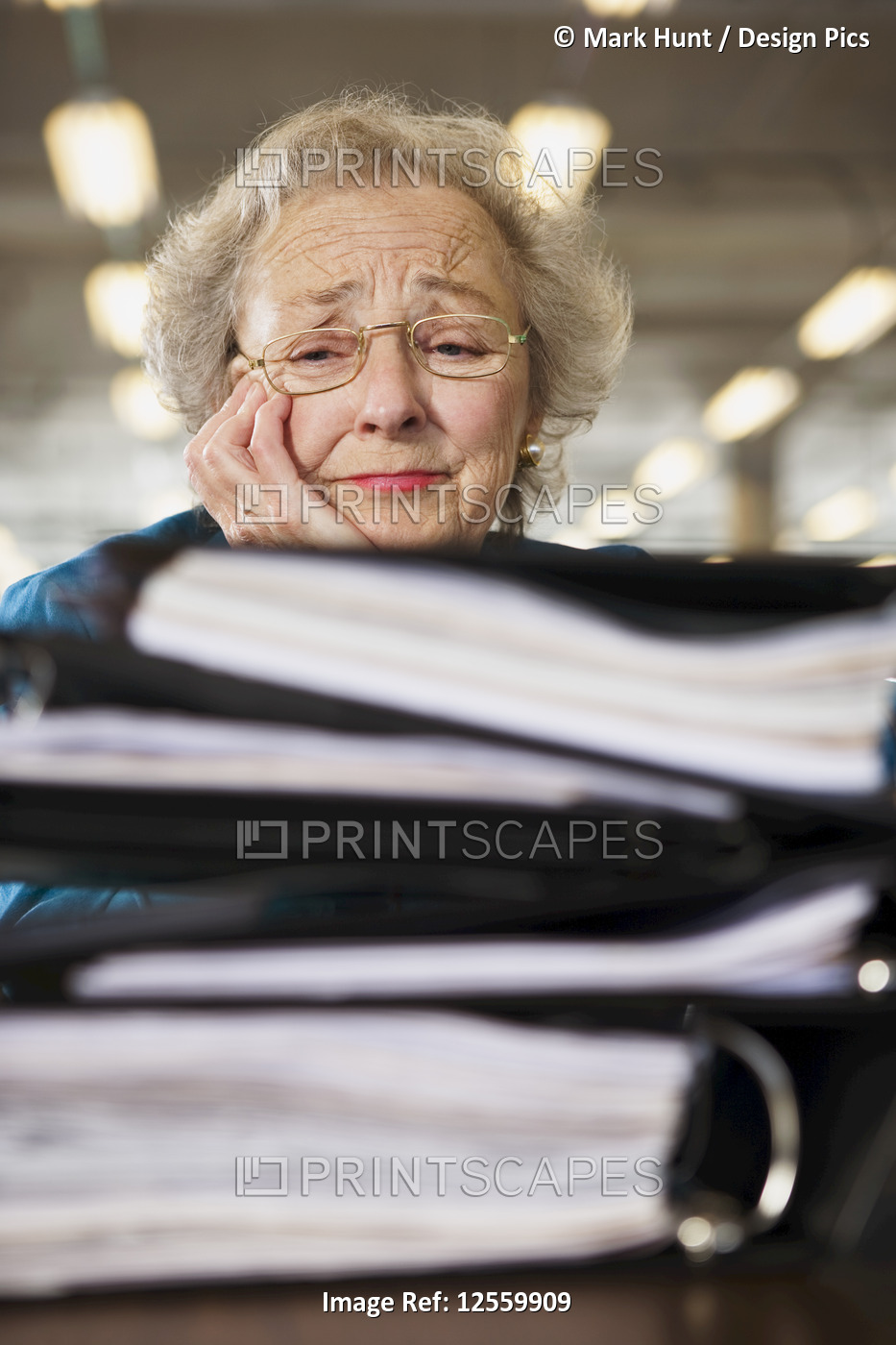 View of a senior woman tensed with workload.