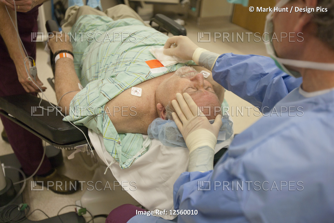 Doctor usng dressing sponge on surgical patient
