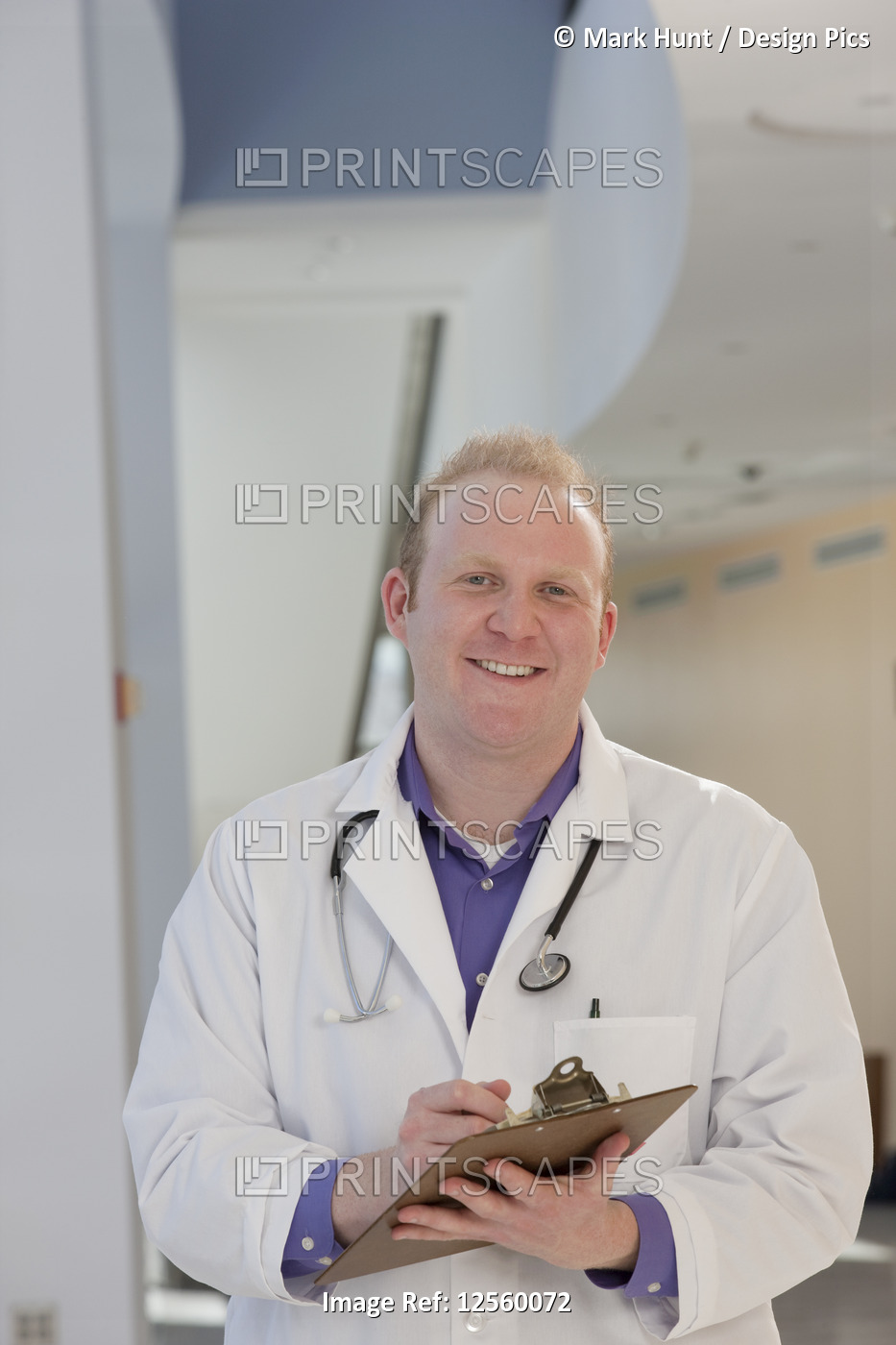 Portrait of a male doctor holding a medical report and smiling