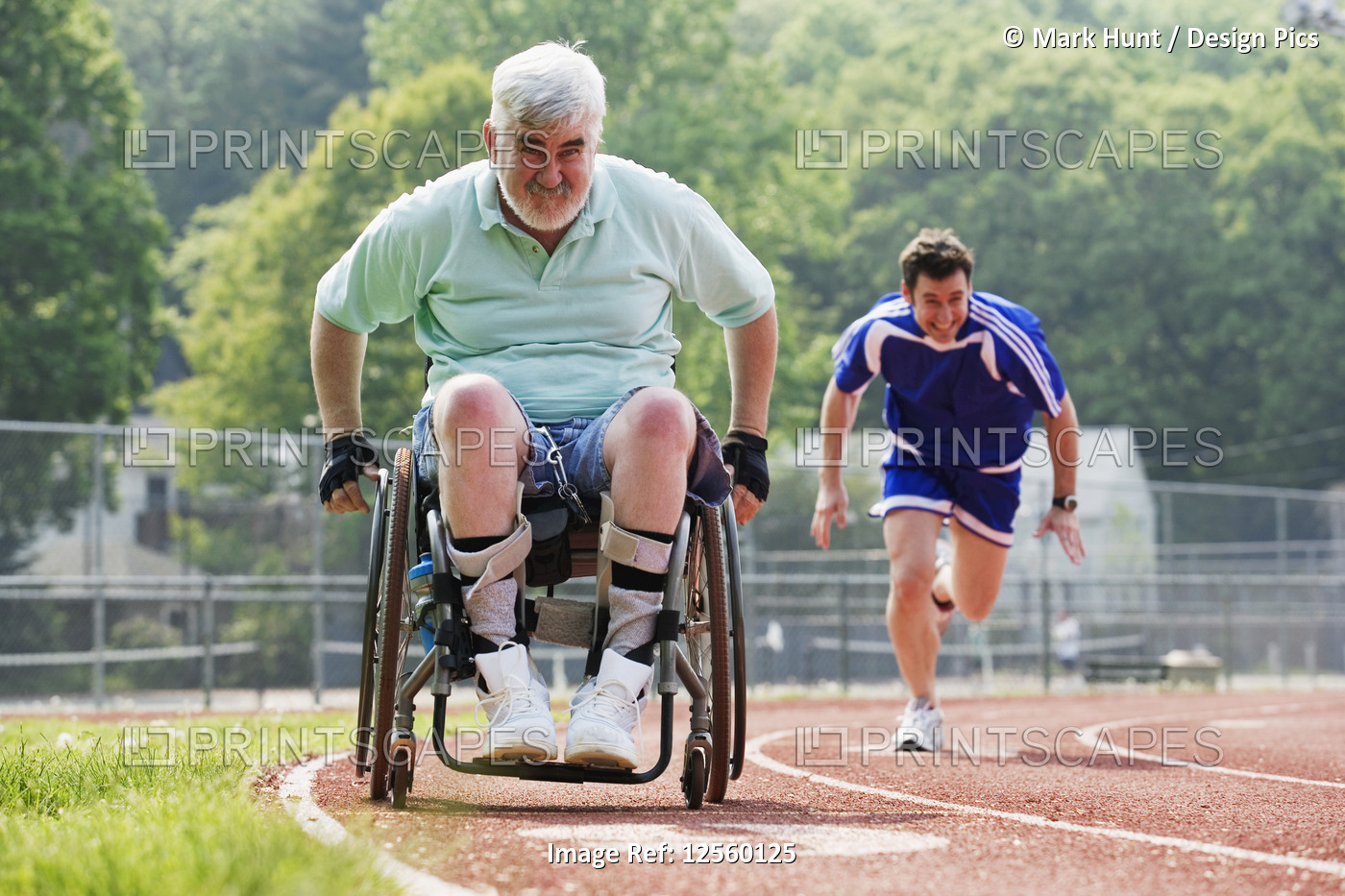 Young man racing with a senior man with Muscular Dystrophy on a racetrack