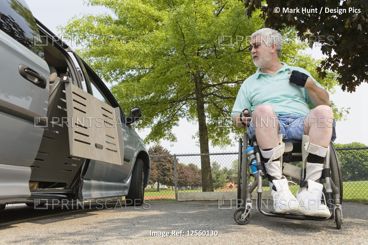 Man with Muscular Dystrophy in wheelchair exiting an accessible van
