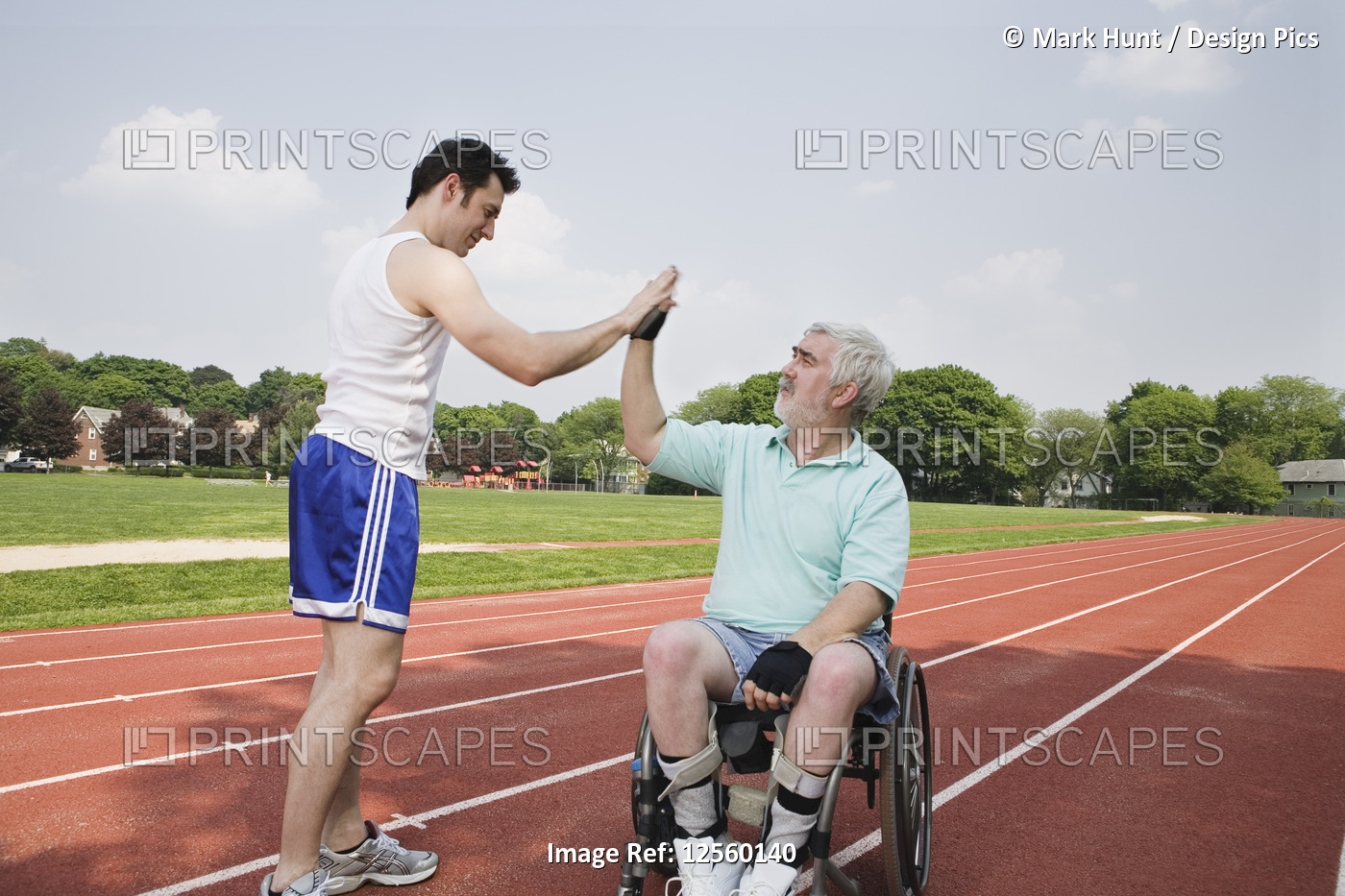 Man with Muscular Dystrophy shaking hands with runner on a race track