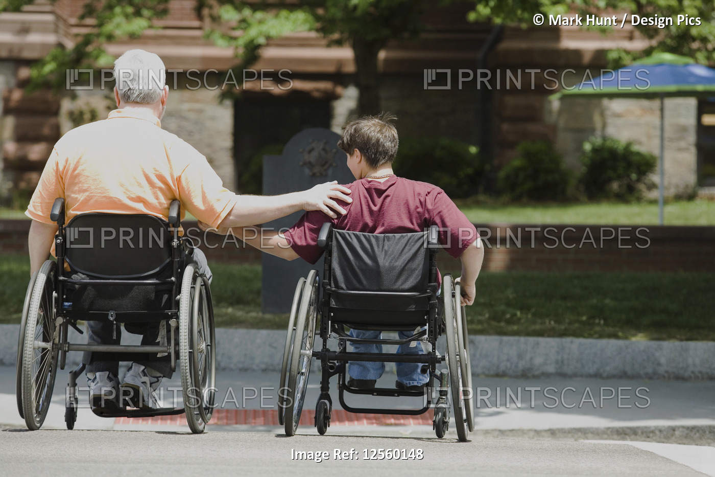 Rear view of a middle-aged man and a middle-aged woman with Muscular Dystrophy ...