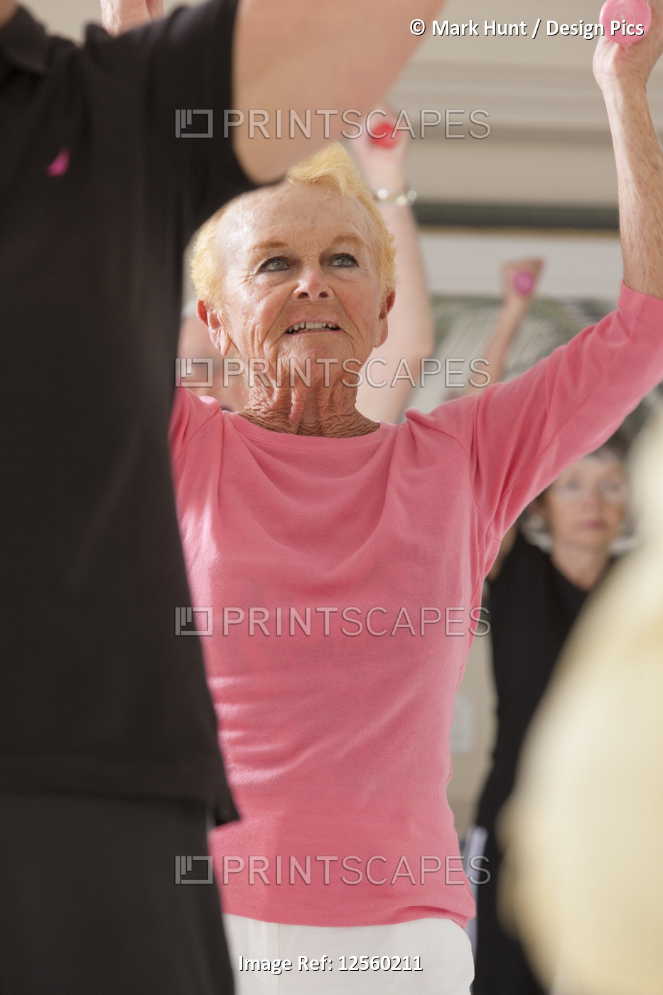 Seniors exercising with dumbbells in a health club
