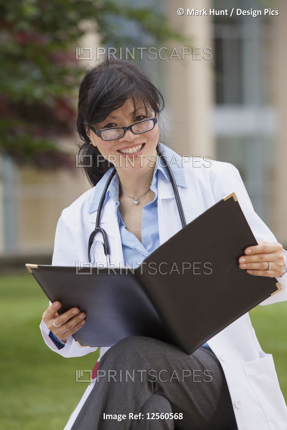 Female doctor studying patient's records