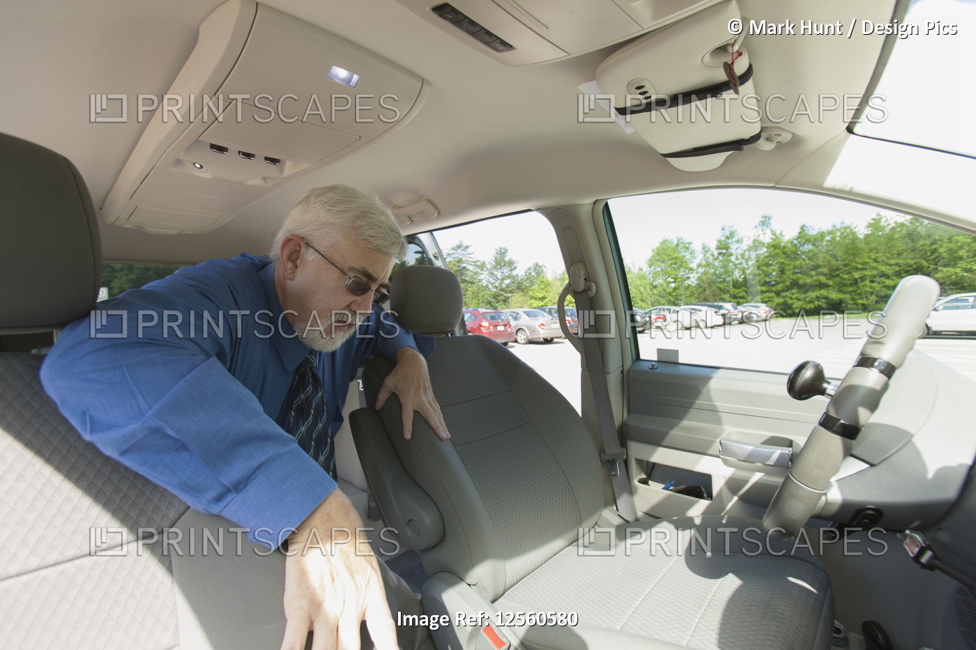 Man with muscular dystrophy and diabetes getting into the front seat of an ...