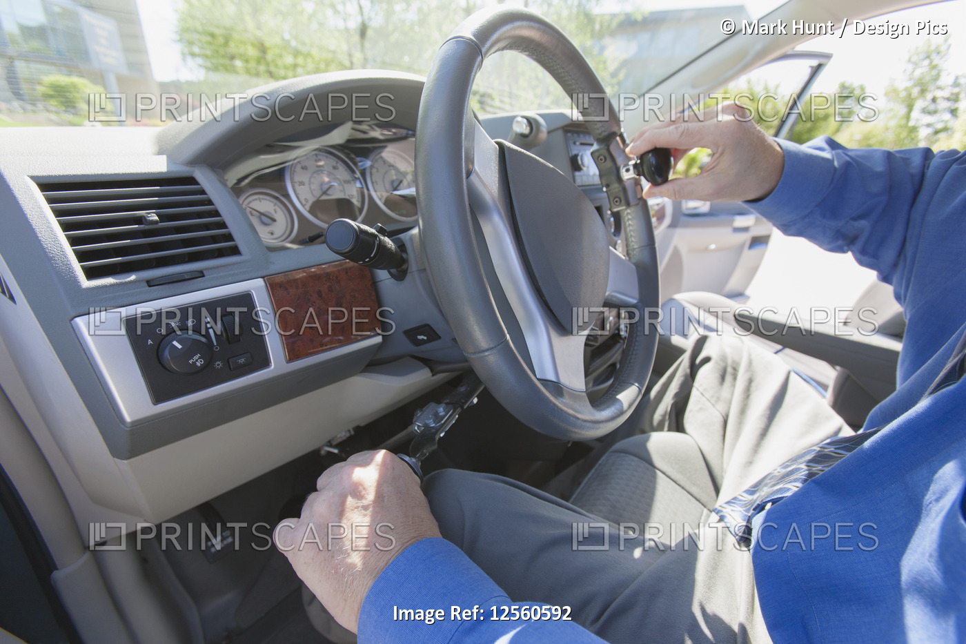 Man with muscular dystrophy and diabetes driving the hand controls of an ...