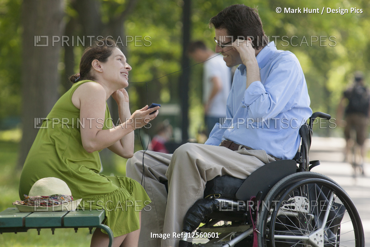 Pregnant wife with husband in wheelchair with spinal cord injury listening to ...