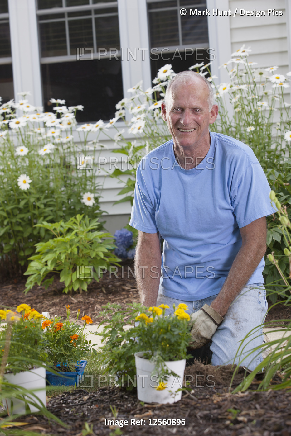 Senior man preparing to plant flowers in his garden