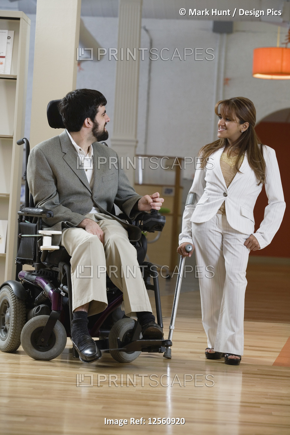 View of a man with Cerebral Palsy and woman conversing.
