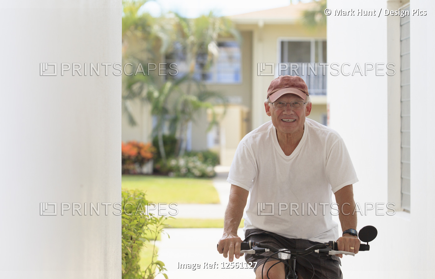 Senior man smiling on a bicycle
