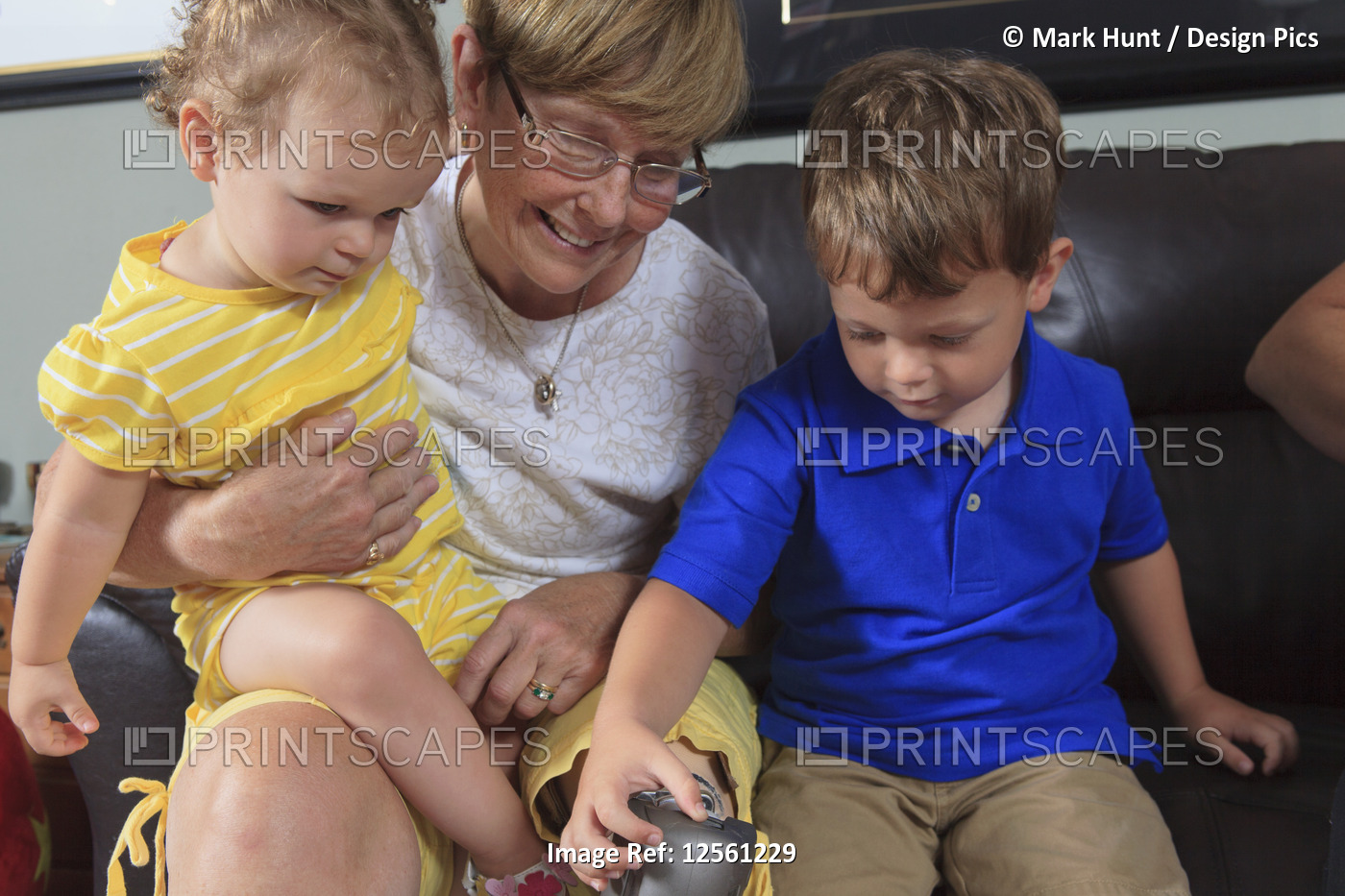 Grandmother with prosthetic leg allowing her grandchildren to play with her leg